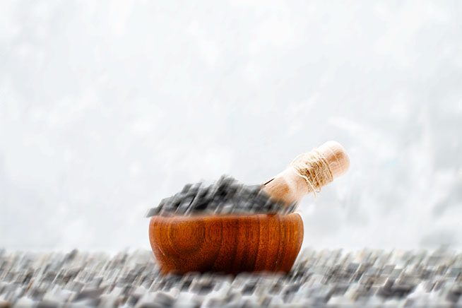 motion blurred image of seeds with pestle and mortar