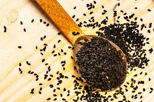 black seeds on a wooden spoon - prestige provisions