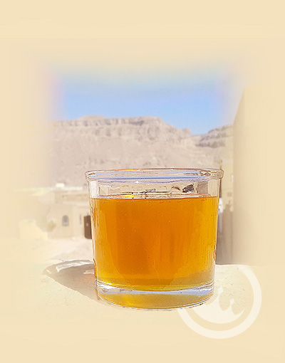 glass of yemeni sidr honey in front of valley - yemeni sidr honey wholesale - prestige provisions