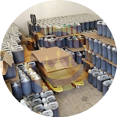 numerous wholesale yemeni sidr honey jerrycans in storage facility with forklift in the midst