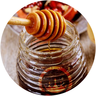 honey wooden dipper over honey jar